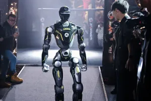 URKL T800 robot walking out through the tunnel with fans and photographers on either side