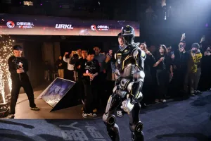 URKL T800 robot walking out on stage past sparklers as the crowd films on their phones