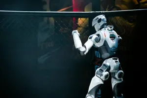 URKL T800 robot facing the fence with a fist raised during a match